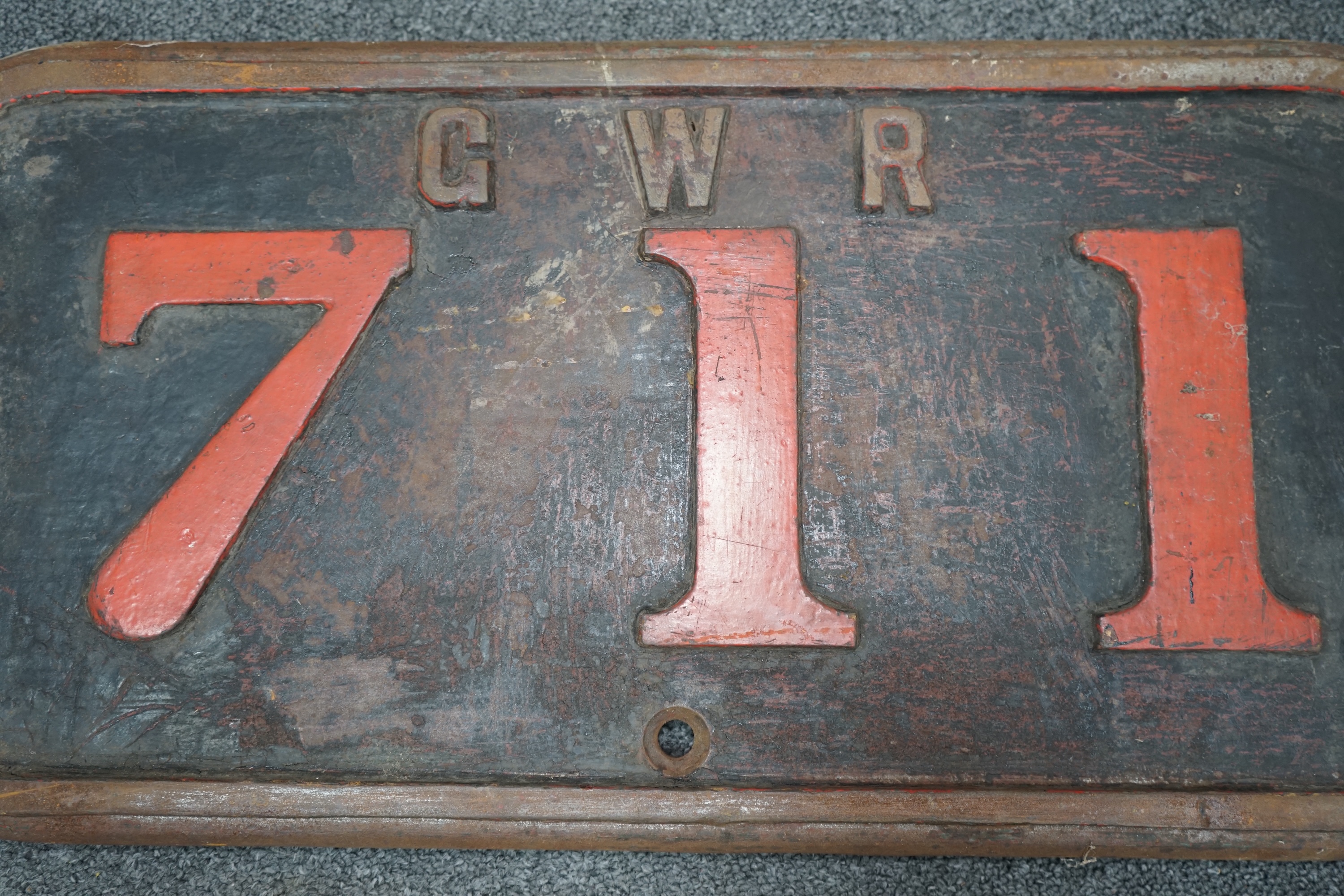 A cast iron GWR locomotive cab side number plate for a Class F 0-6-0ST locomotive, 711, built in 1890 for the Barry Railway, and withdrawn by the GWR in 1934 and sold to Powell Duffryn Coal Co., the locomotive was scrapp